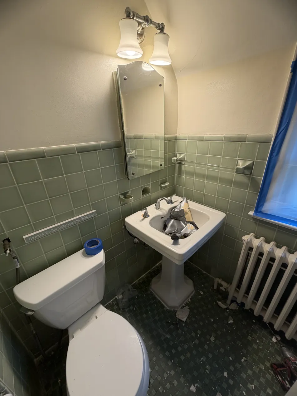 Scarsdale guest bathroom before renovation showing dated green tile and pedestal sink