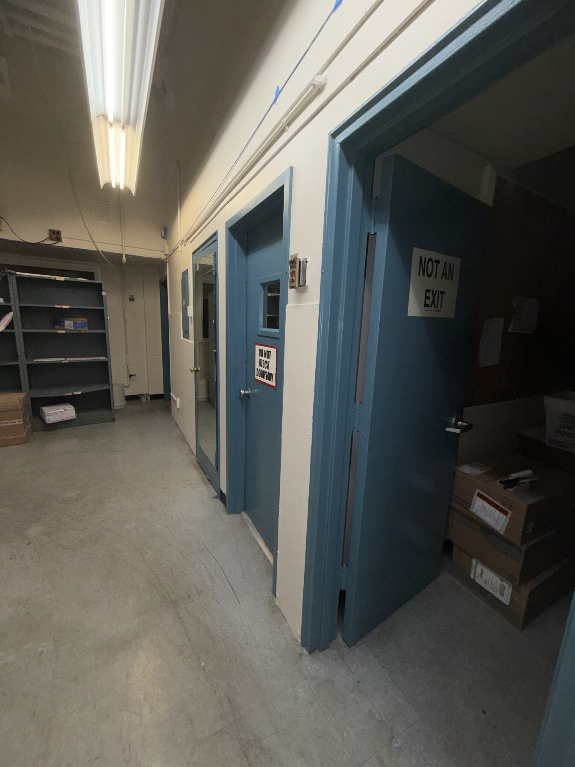 Repainted metal doors with durable enamel finish in postal facility