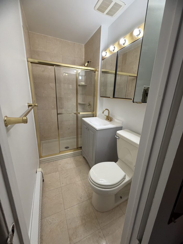 Bathroom in Scarsdale NY after new vanity, sink, brass faucet and painting by GCMM Home Improvement