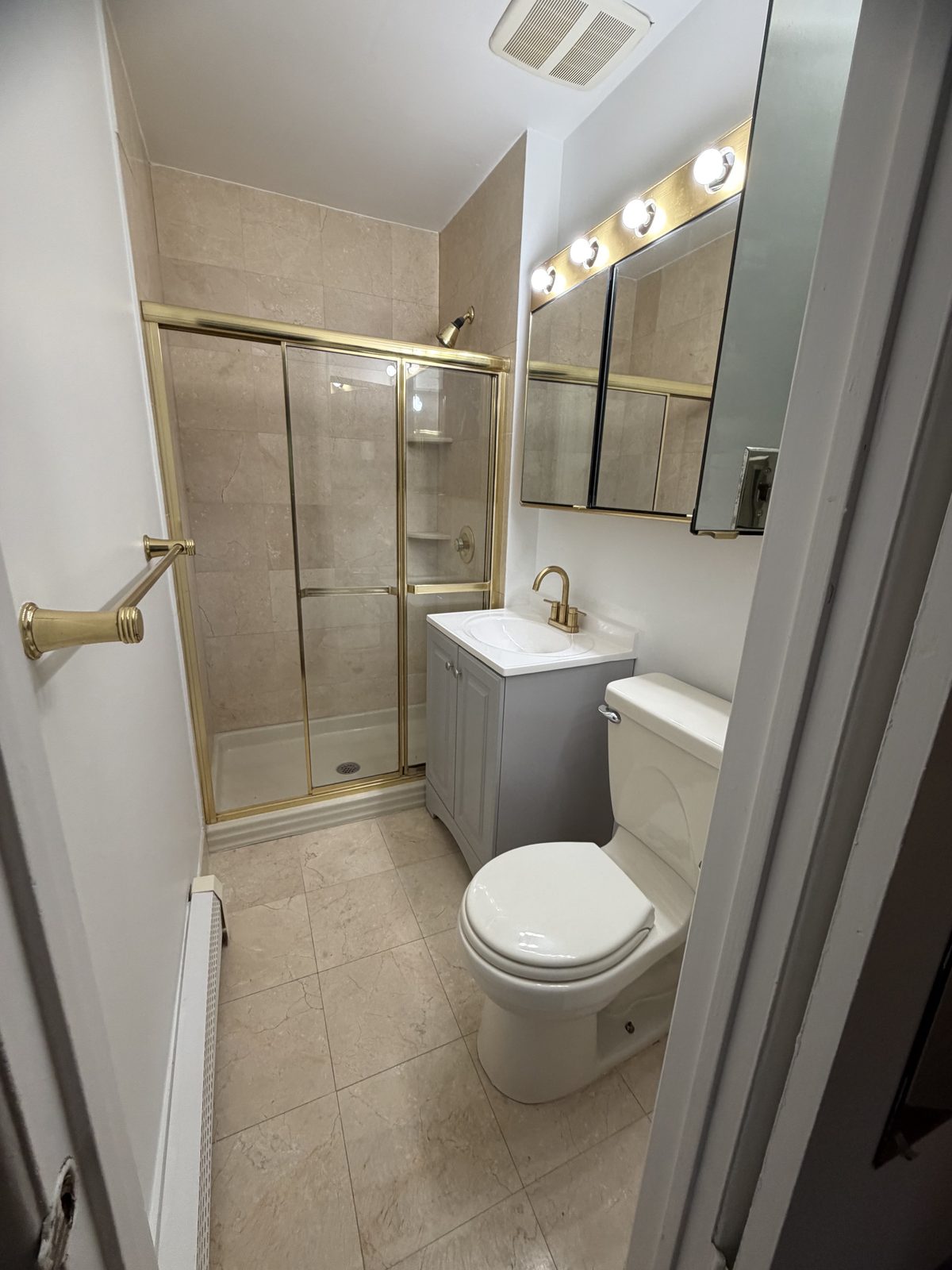 Scarsdale NY bathroom with new vanity, brass faucet and fresh paint
