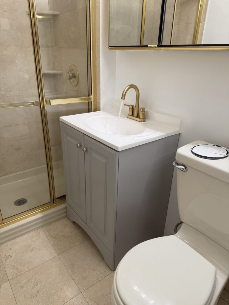 Bathroom in Scarsdale NY after new vanity, sink, brass faucet and painting by GCMM Home Improvement