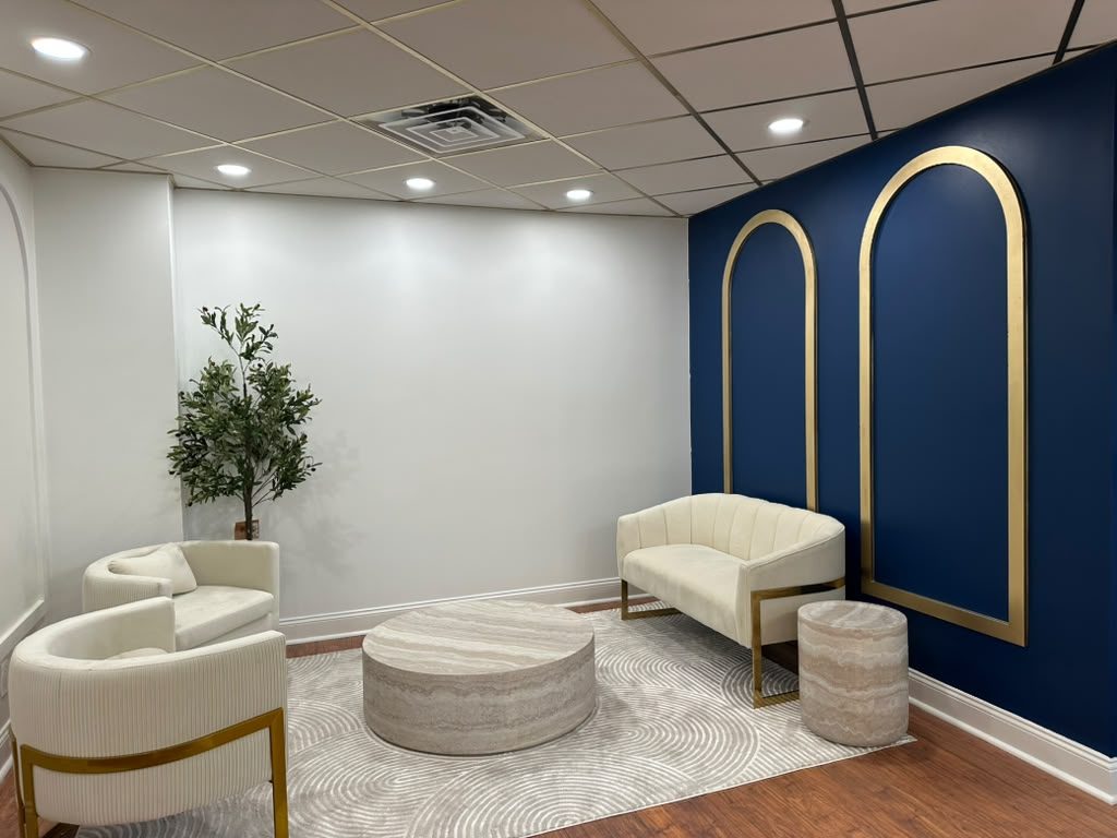 Dental office reception in Scarsdale NY with new front desk, arched wall panels and navy accent wall built by GCMM Dental Construction